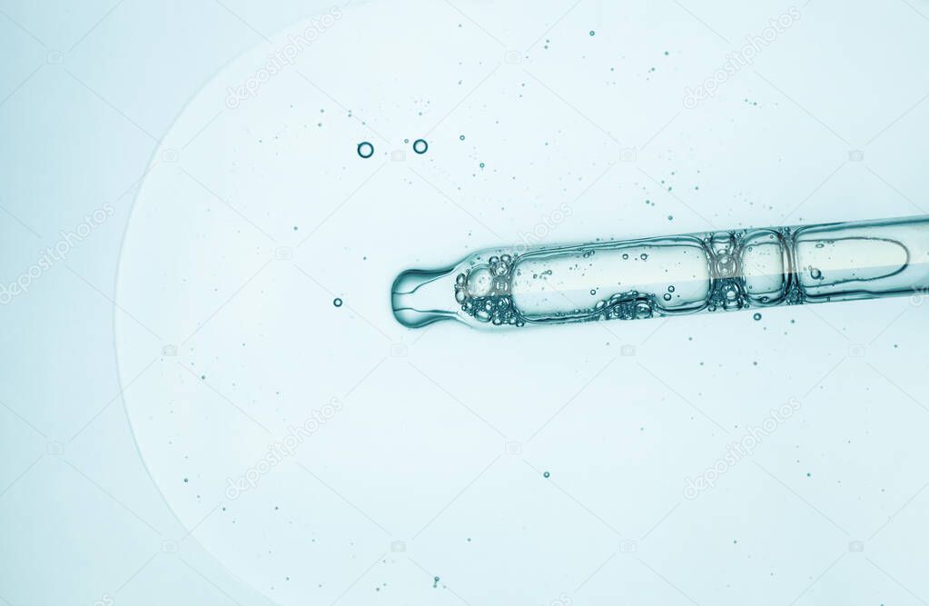 Liquid cosmetic moisturizing gel or serum swatch on glass of microscop background