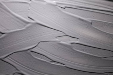 Gri, siyah kil veya çamur veya kömür maskesi dokusu kozmetik arka plan