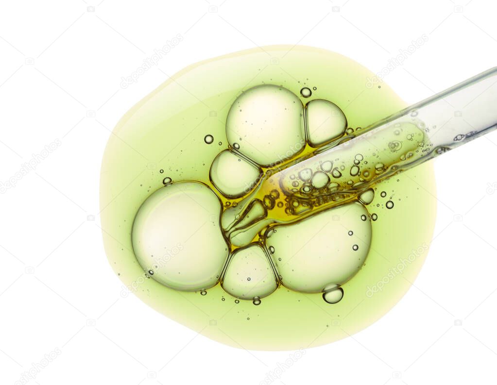 Liquid green gel or serum drop and pipette on white isolated background