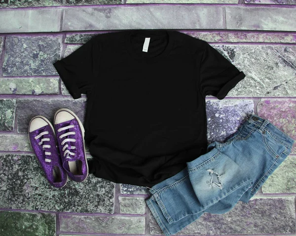 Tricou negru mockup plat pus pe fundal de cărămidă violet cu pu — Fotografie, imagine de stoc