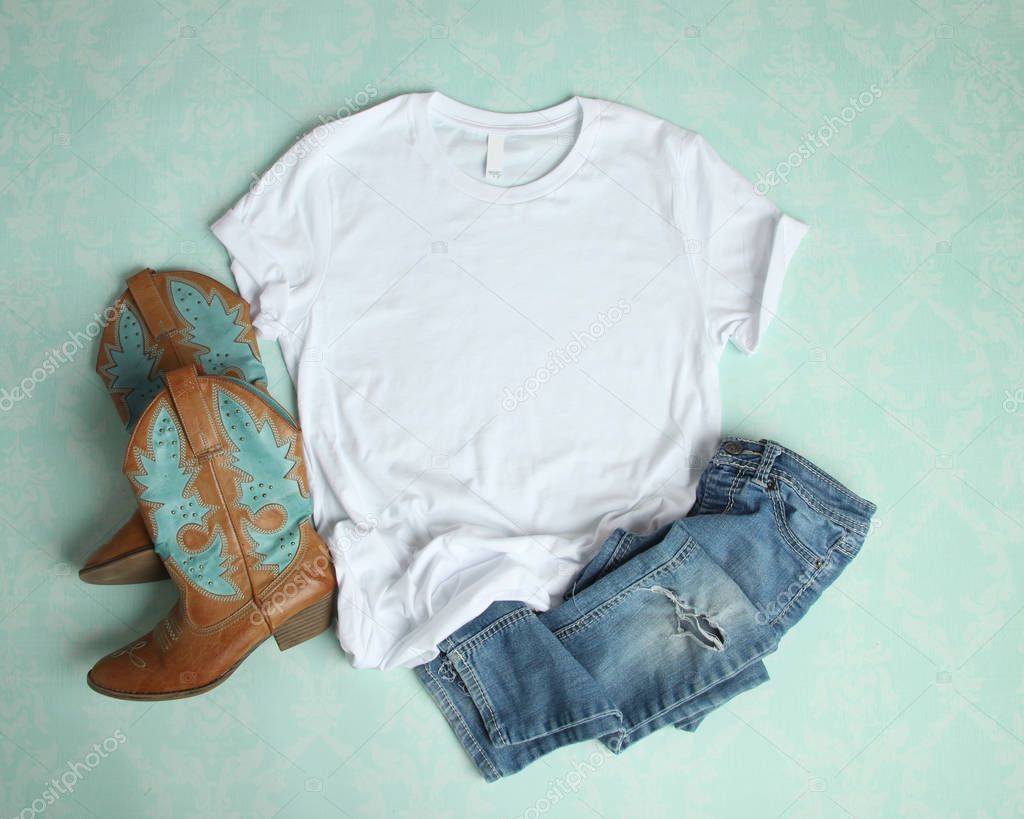 White T Shirt Flat Lay Mockup on aqua background with cowboy boots and ripped jeans