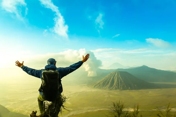 hiker winning reaching life goal, success, freedom and happiness, achievement in mountains.Kawah Ijen.Indonesia.