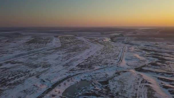 Snow-covered fields at sunset from a birds eye view — Stock Video