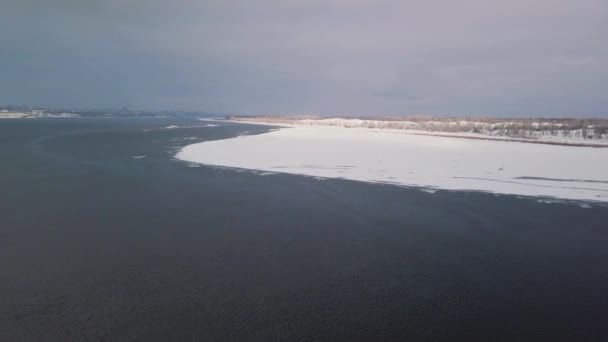Flying over the winter river shooting video from a drone — 비디오