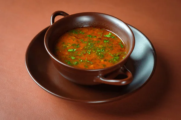 Georgian borsch in a plate on a brown table — Stock Photo, Image