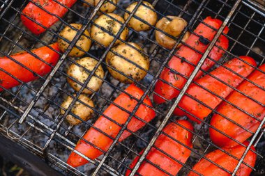 Vegetables and mushrooms fried in a grill on a grill, close-up