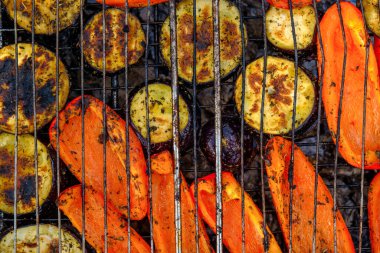 Vegetables and mushrooms fried in a grill on a grill, close-up