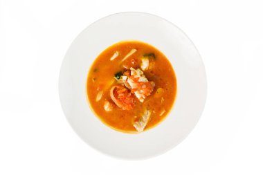 Beyaz arka planda bir kasede balık çorbası. Üst görünüm, yakın çekim