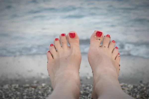 Female feet on  sea beach — Stock Photo, Image