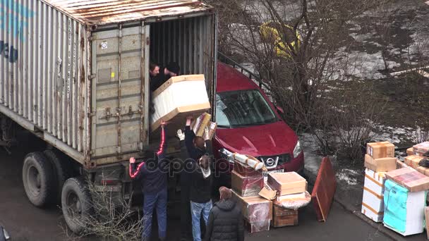 Los trabajadores descargan artículos de la furgoneta. 4K . — Vídeo de stock