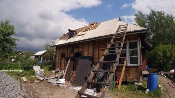 Werknemers ontmanteld het dak van een houten huis. 4k. — Stockvideo