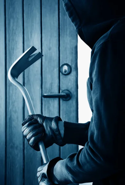 Burglar holding crowbar — Stock Photo, Image