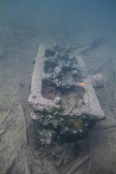 Large piece of a engin at the bottom of a lake