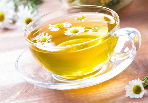 Tea herbs healing chamomile wooden background