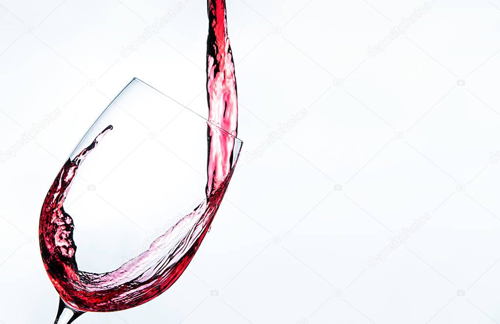 Romantic drink red wine on the glass on white background with splash