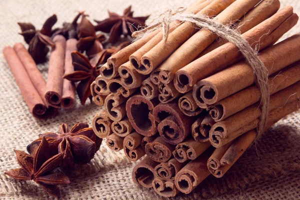 Star anise and bunch of cinnamon on a sackcloth Stock Photo