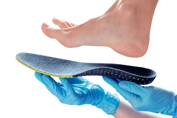 Orthopedic insole in the hands — Stock Photo, Image