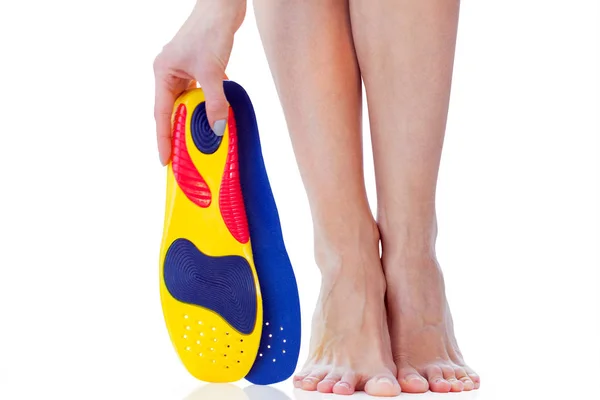 Orthopedic insoles and female feet — Stock Photo, Image