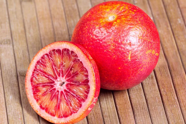 Blood orange on a wooden striped background — Stock Photo, Image