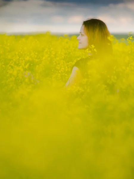 Beautiful russian girl in a canola field — Stock Photo, Image