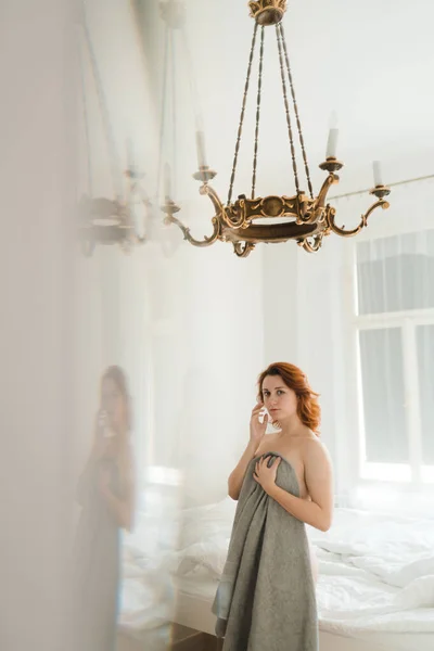 Redhead womans lazy morning in a sunny vintage room with no clothes and naked body parts - Holding grey towel