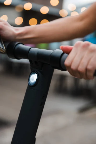 Fit Woman stands with electric scooter, rides away - Shot of Modern transportation gadget and popular futuristic device among young people - Eastern European Latvia Riga — Stock Photo, Image