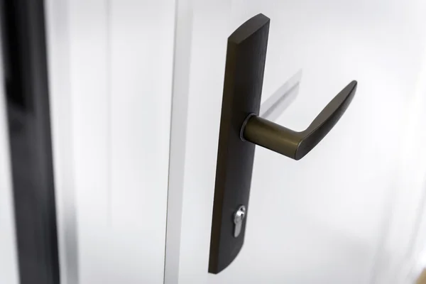 Black door-handle on white surface — Stock Photo, Image