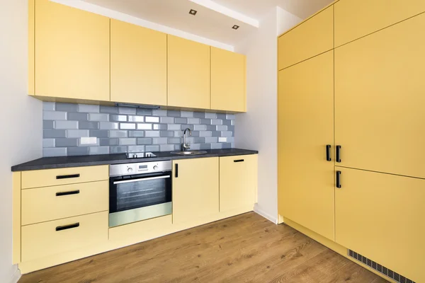 Empty domestic kitchen in yellow color — Stock Photo, Image