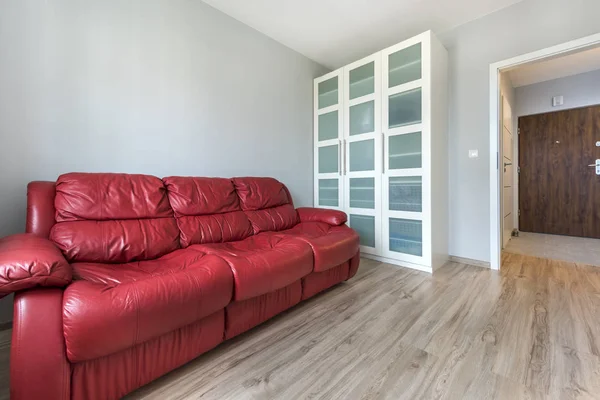 Red sofa in empty room — Stock Photo, Image