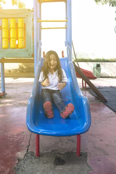 Happy children on slide at playground area — Stock Photo, Image