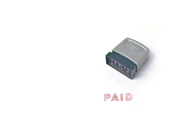 "PAID "Rubber stamp on a white background — стоковое фото