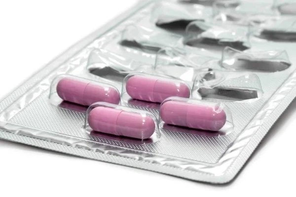 Packets of four pink pills (Capsules) — Stock Photo, Image