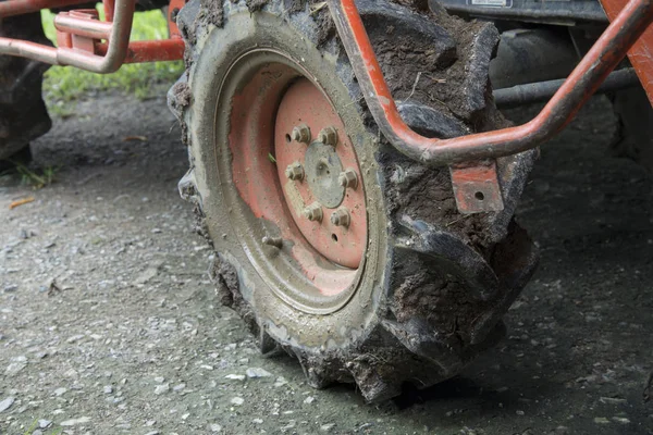 Close up dirty wheel of orange farm tractor — Stock Photo, Image
