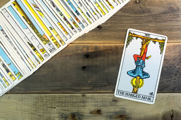 "THE HANGED MAN" tarot cards on the table.