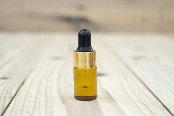 Bottle serum for beauty treatment on wooden background. — Stock Photo, Image