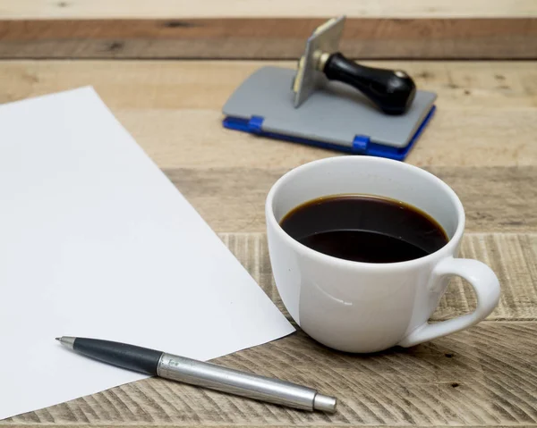 Carta bianca con tazza di caffè su sfondo di legno . — Foto Stock
