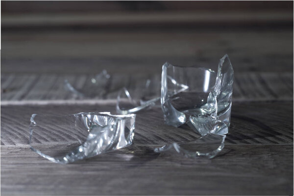 Broken glass on wooden background.