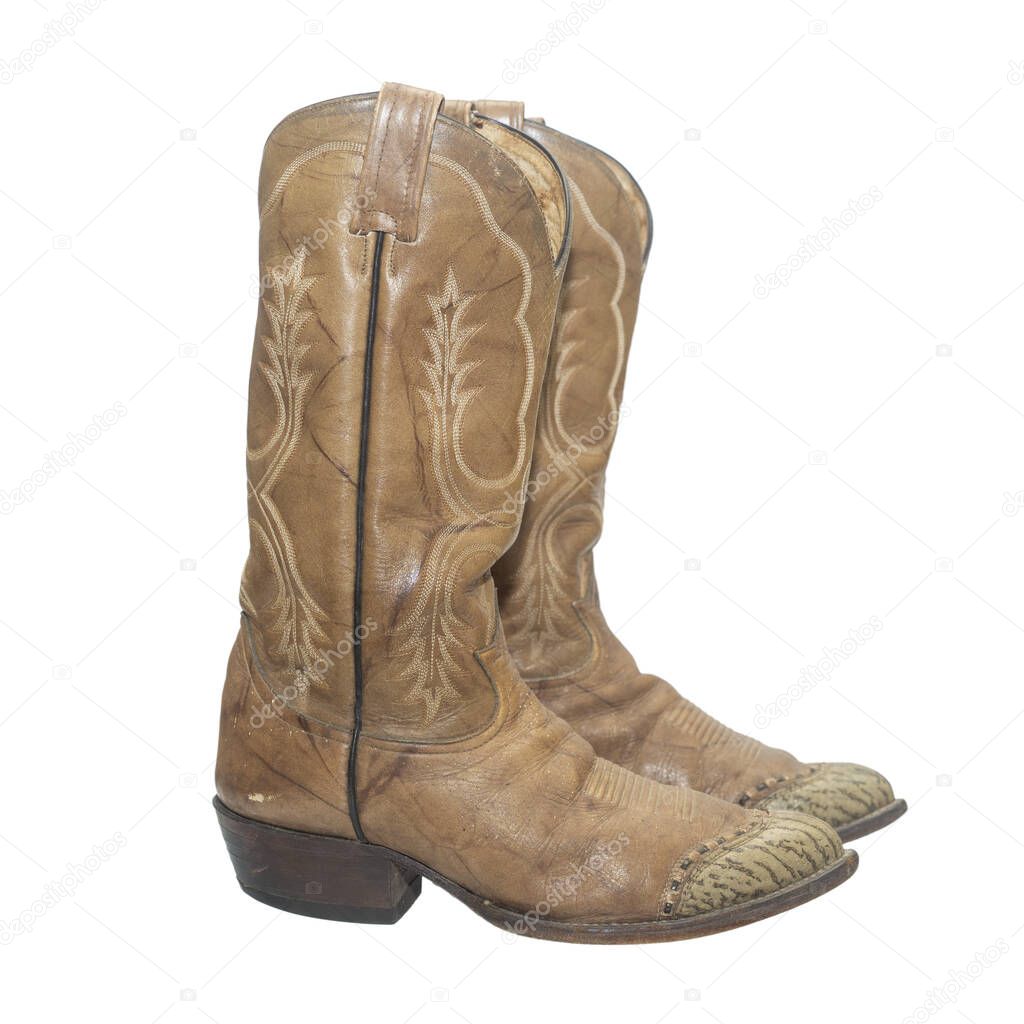 Brown cowboy boots isolated on a white background.