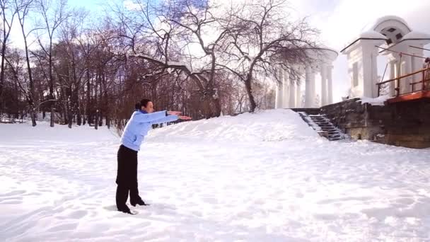 Young woman practicing yoga gymnastics in the winter outdoors — 비디오