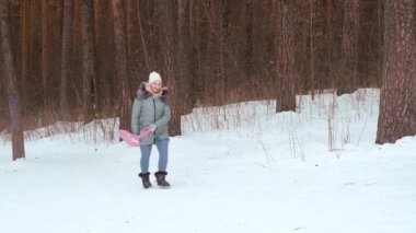 Bir kadın buz üzerinde yokuş aşağı kayıyor. Kış eğlencesi