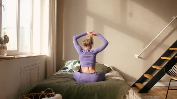 Young beautiful woman practices yoga at home. Room interior. — Stock Video