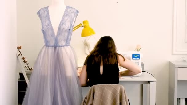 Female tailor working in her studio with sewing machine — Stock Video