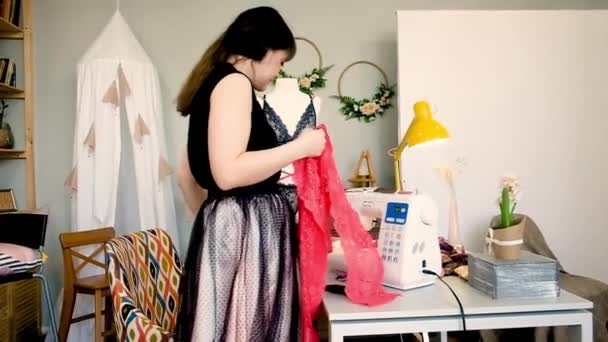 Woman tailor sews lace sexy lingerie in a sewing studio. Fashion style. Sews on a sewing machine. — Stock Video