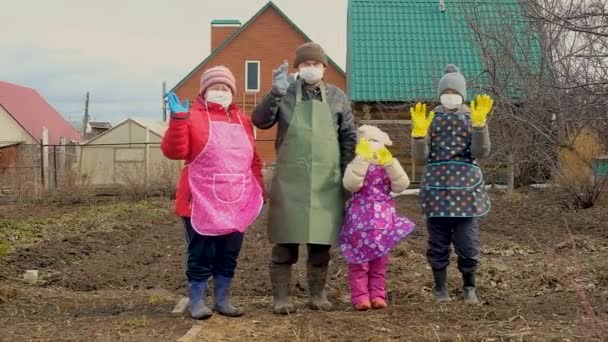 Бабуся, дідусь з онуками в медичній масці і рукавичках для прогулянки по країні. Коронавірус — стокове відео