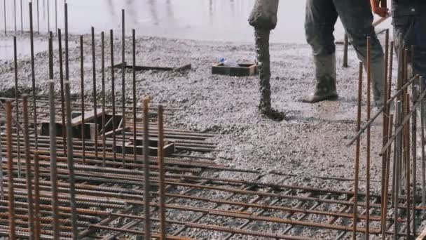 Bouwer, arbeider giet cement of beton met een pomp buis. Betonbekisting. — Stockvideo