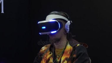 Sony kürsüye Sony Vr kulaklık aksesuarları denetleyicisi olan sanal gerçeklik oyunu oynayan adam