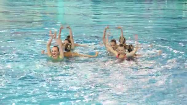 Perfomance van meisjes gesynchroniseerd zwemmers — Stockvideo