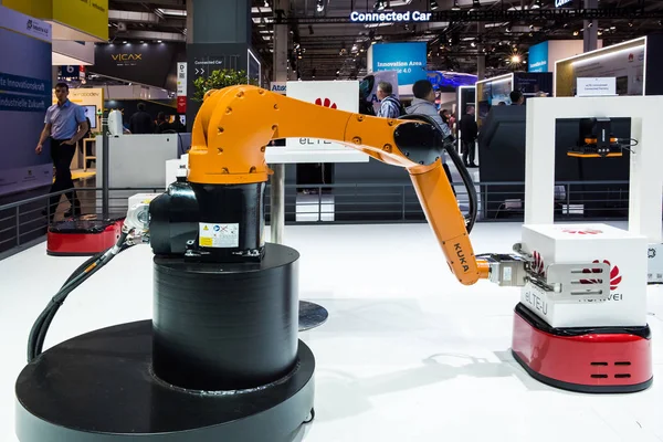 Kuka industrial robot on Huawei booth stand on Messe fair in Hannover, Germany Stock Image