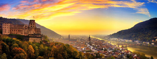 Heidelberg, Germany, aerial panoramic view at dusk, with colorful sunset sky, the castle, Neckar river and the Old Bridge