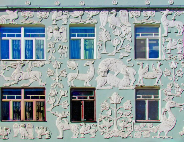 Reliefs of fantastic animals on the facade of a residential building